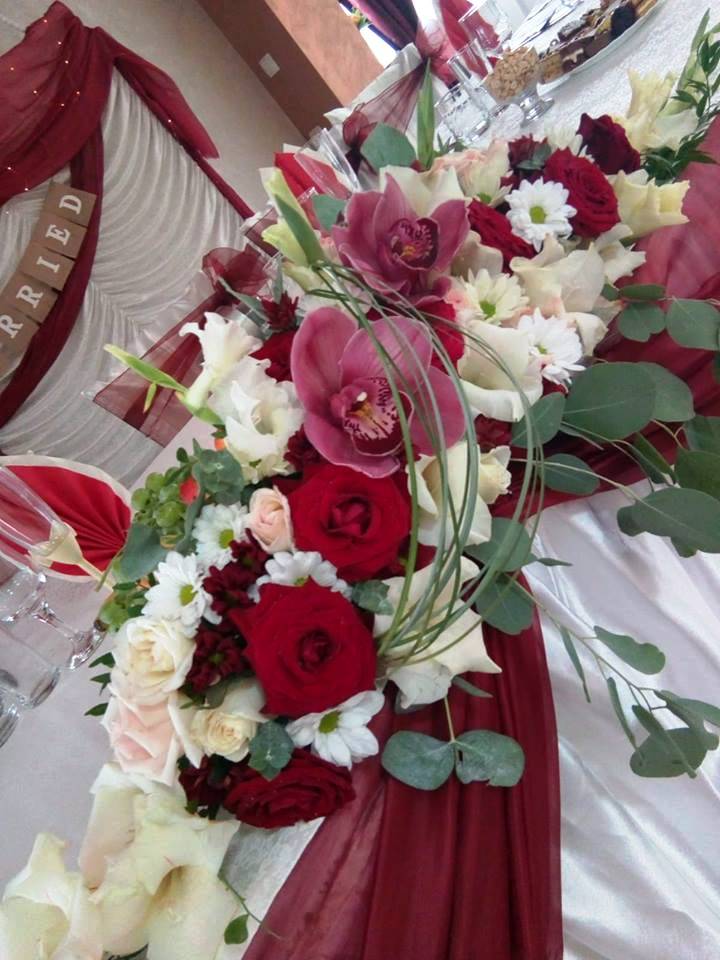 Mix de nuante, realizat cu trandafiri rosii Red Naomi, cupe de orhidee Cymbidium, gladiole, crizanteme tip margareta, mult eucalipt